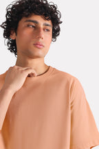 Close-up detail on the terracotta (clay) drop shoulder cotton t-shirt, by SOLA Pakistan.
