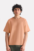 Terracotta (clay) drop shoulder cotton t-shirt, worn by a model, by SOLA Pakistan.