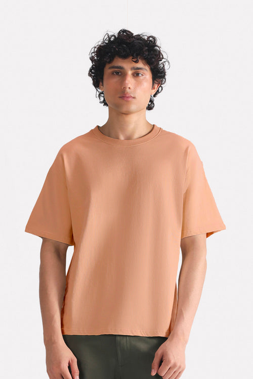 Terracotta (clay) drop shoulder cotton t-shirt, worn by a model, by SOLA Pakistan.