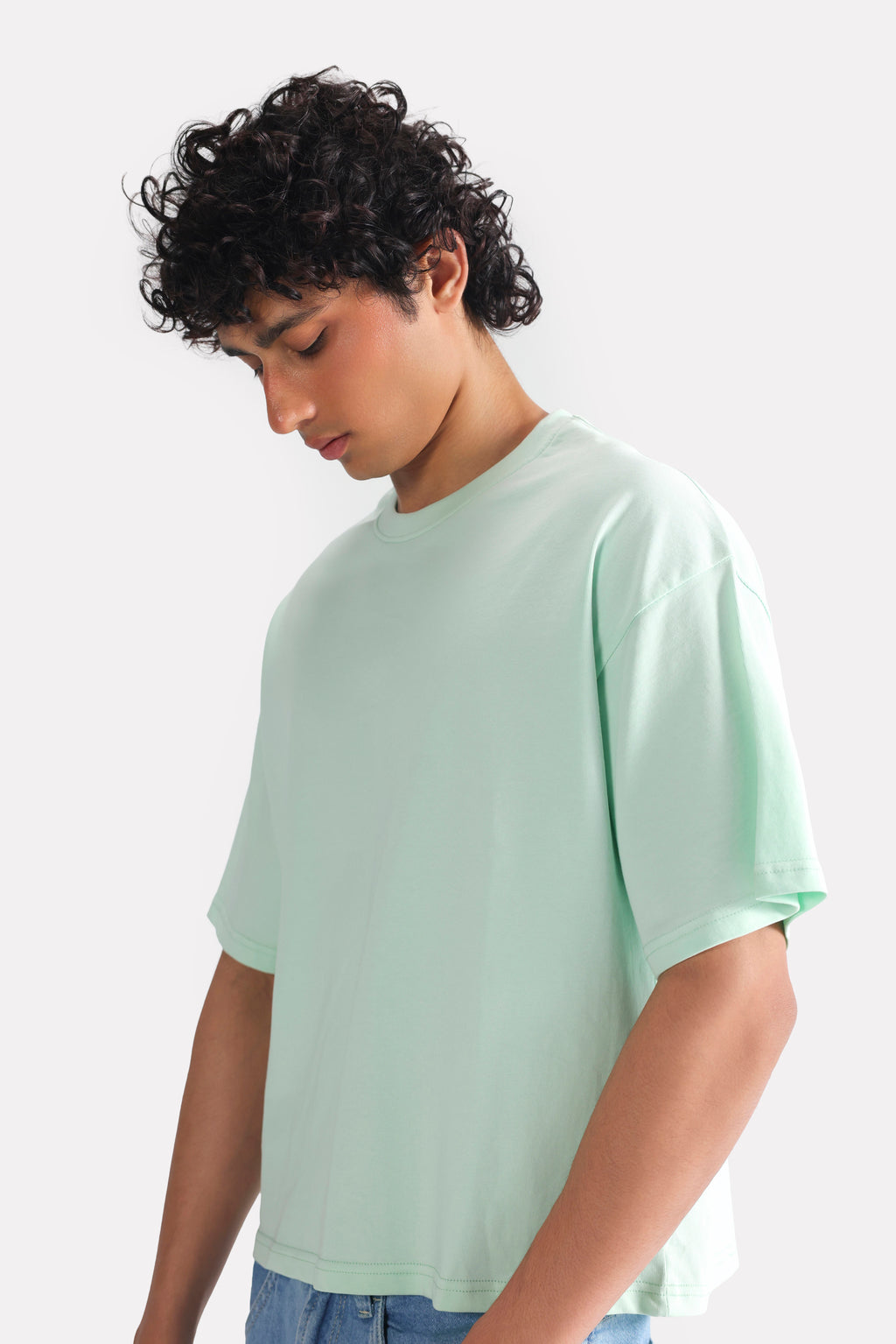 Close-up detail on the turquoise (tourquies) drop shoulder cotton t-shirt, by SOLA Pakistan.