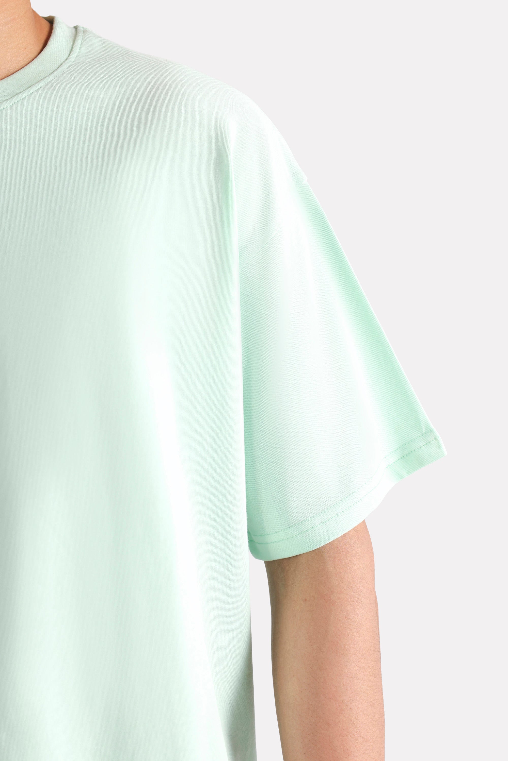 Flat lay of the turquoise (tourquies) drop shoulder cotton t-shirt, by SOLA Pakistan.