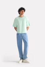 Turquoise (tourquies) drop shoulder cotton t-shirt shown in a styled fit, by SOLA Pakistan.