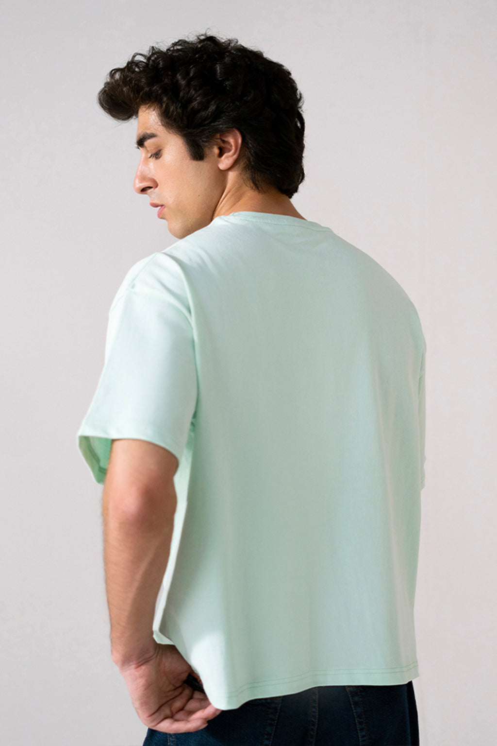Turquoise (tourquies) heavy weight cropped t-shirt shown in a styled fit, by SOLA Pakistan.