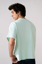 Turquoise (tourquies) heavy weight cropped t-shirt shown in a styled fit, by SOLA Pakistan.