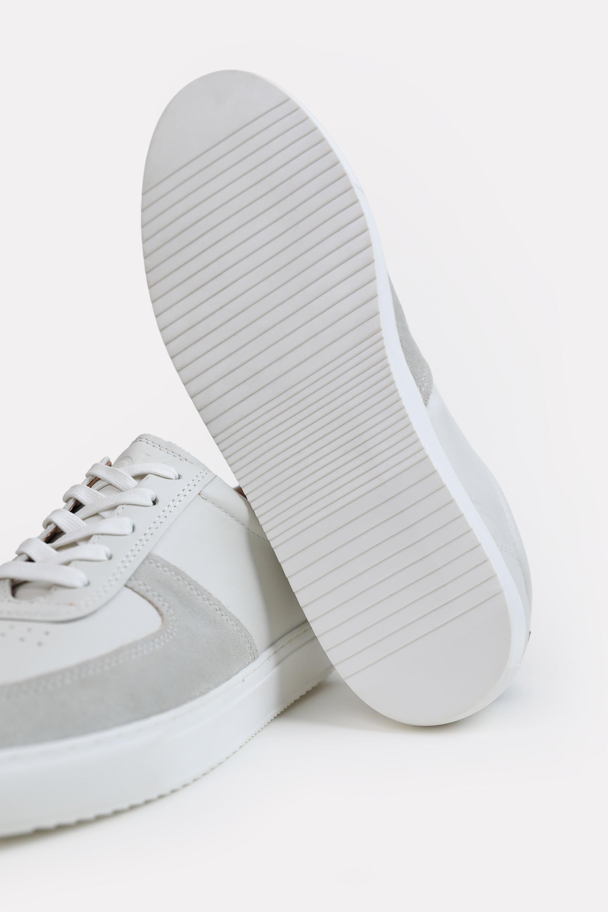 Close-up detail on the white classic leather trainer, by SOLA Pakistan.