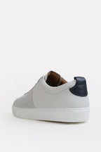 Flat lay of the white classic leather trainer, by SOLA Pakistan.