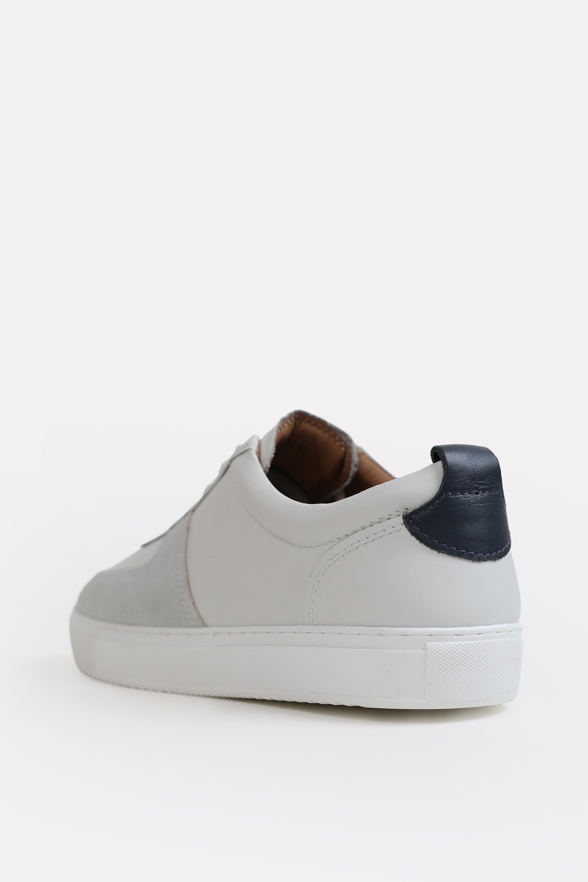 Flat lay of the white classic leather trainer, by SOLA Pakistan.