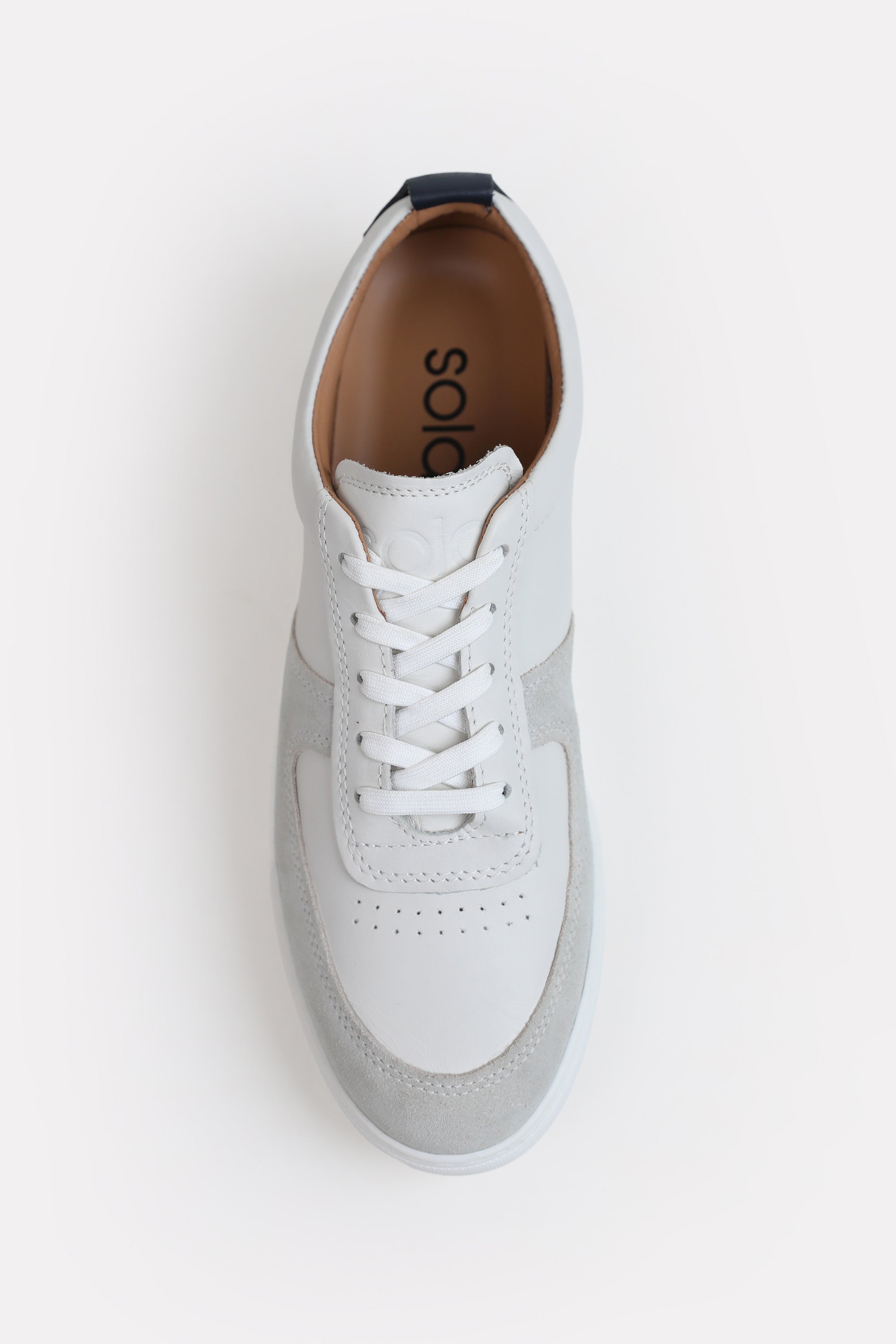 White classic leather trainer shown in detail, by SOLA Pakistan.