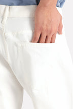 Close-up detail on the white garment-dyed casual trouser, by SOLA Pakistan.