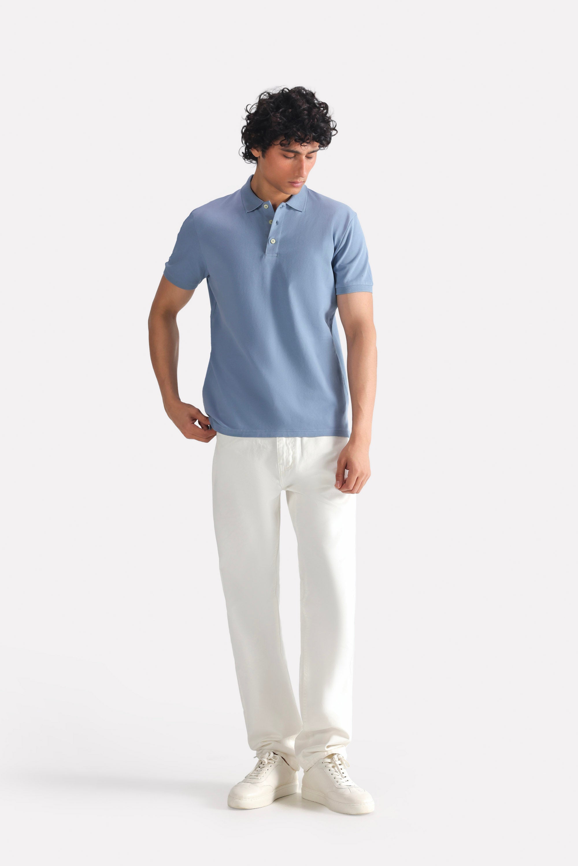 White garment-dyed casual trouser in cotton, worn by a model, by SOLA Pakistan.