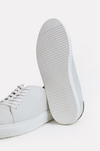 Close-up detail on the white leather trainers-detailed heel, by SOLA Pakistan.