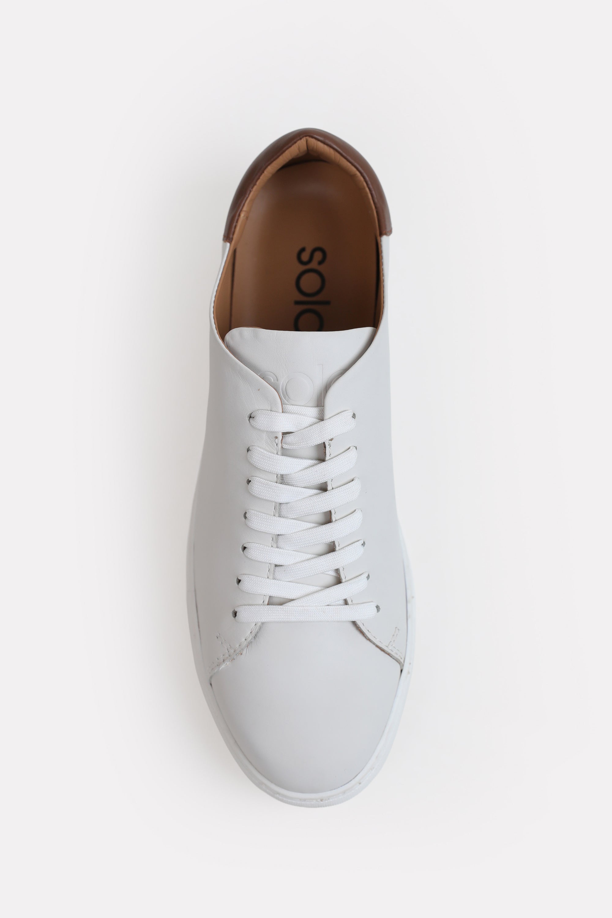 White leather trainers-detailed heel shown in detail, by SOLA Pakistan.