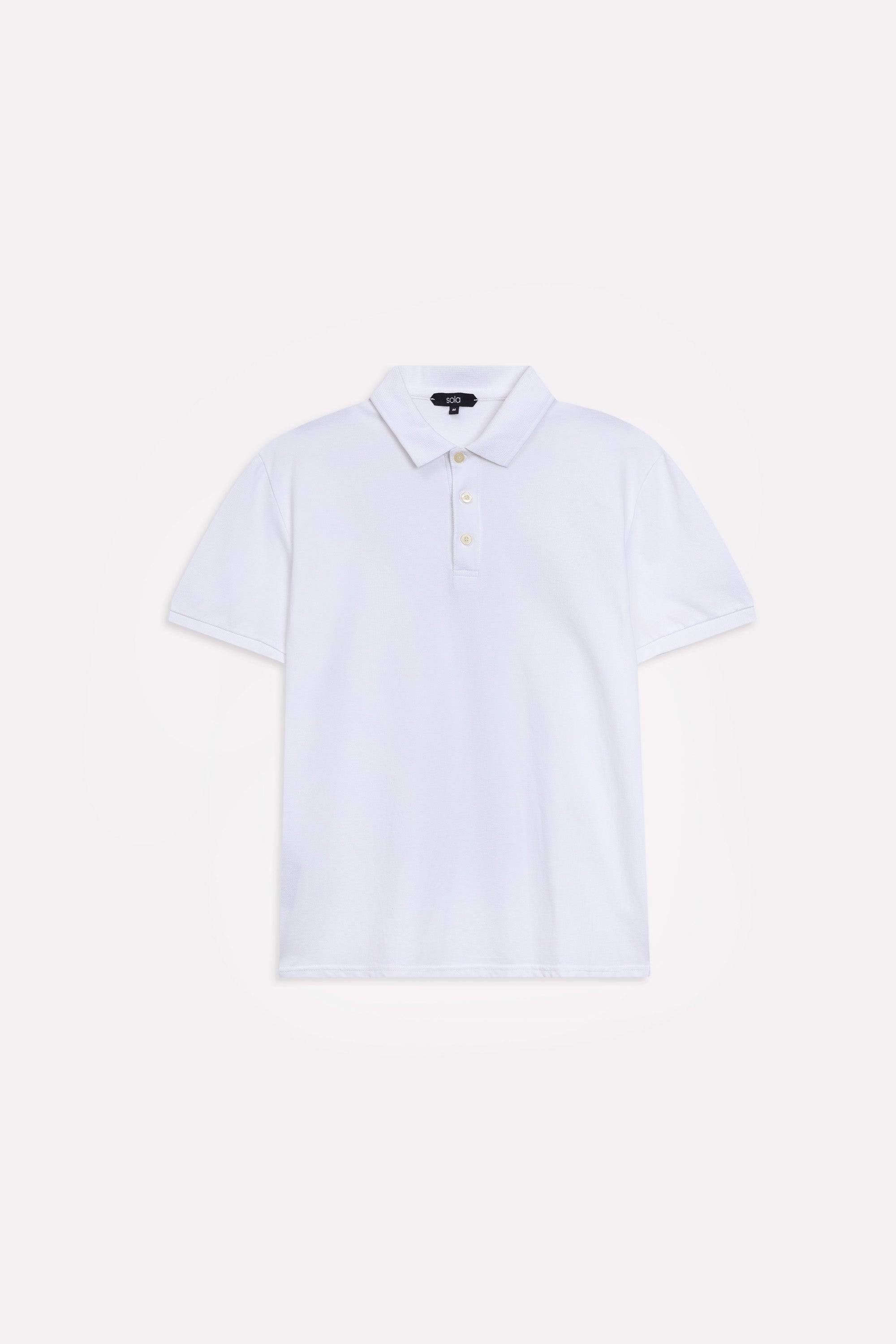 Flat lay of the white micro-textured cotton pique polo, by SOLA Pakistan.