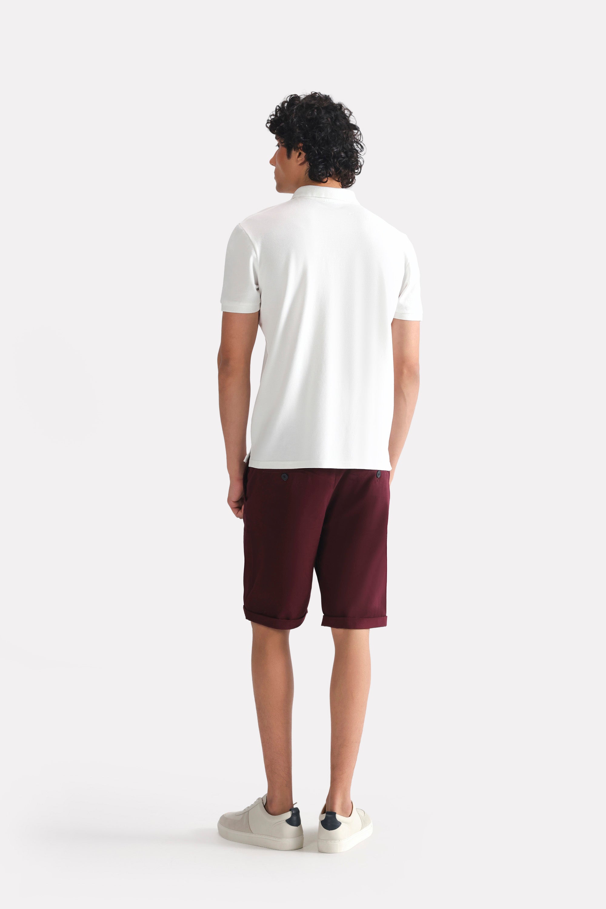White micro-textured cotton pique polo shown in a styled fit, by SOLA Pakistan.