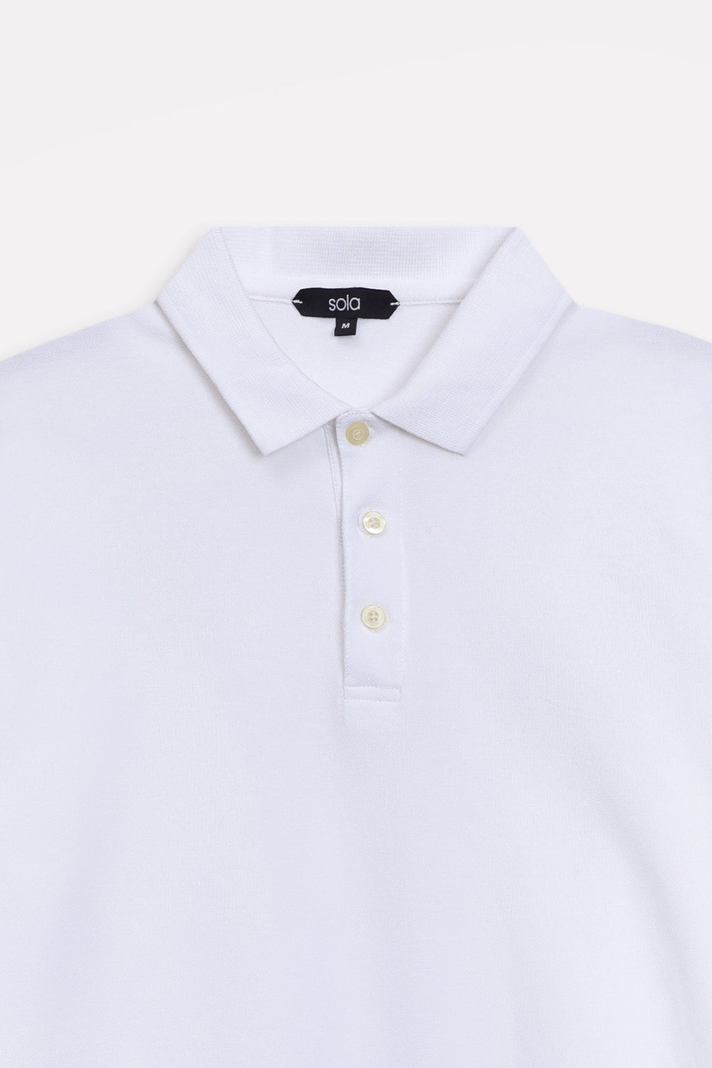 Texture and fabric detail, white micro-textured cotton pique polo, by SOLA Pakistan.