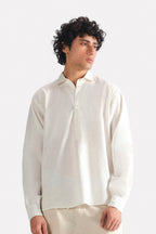 White pop over half-placket shirt in cotton-linen blend, worn by a model, by SOLA Pakistan.