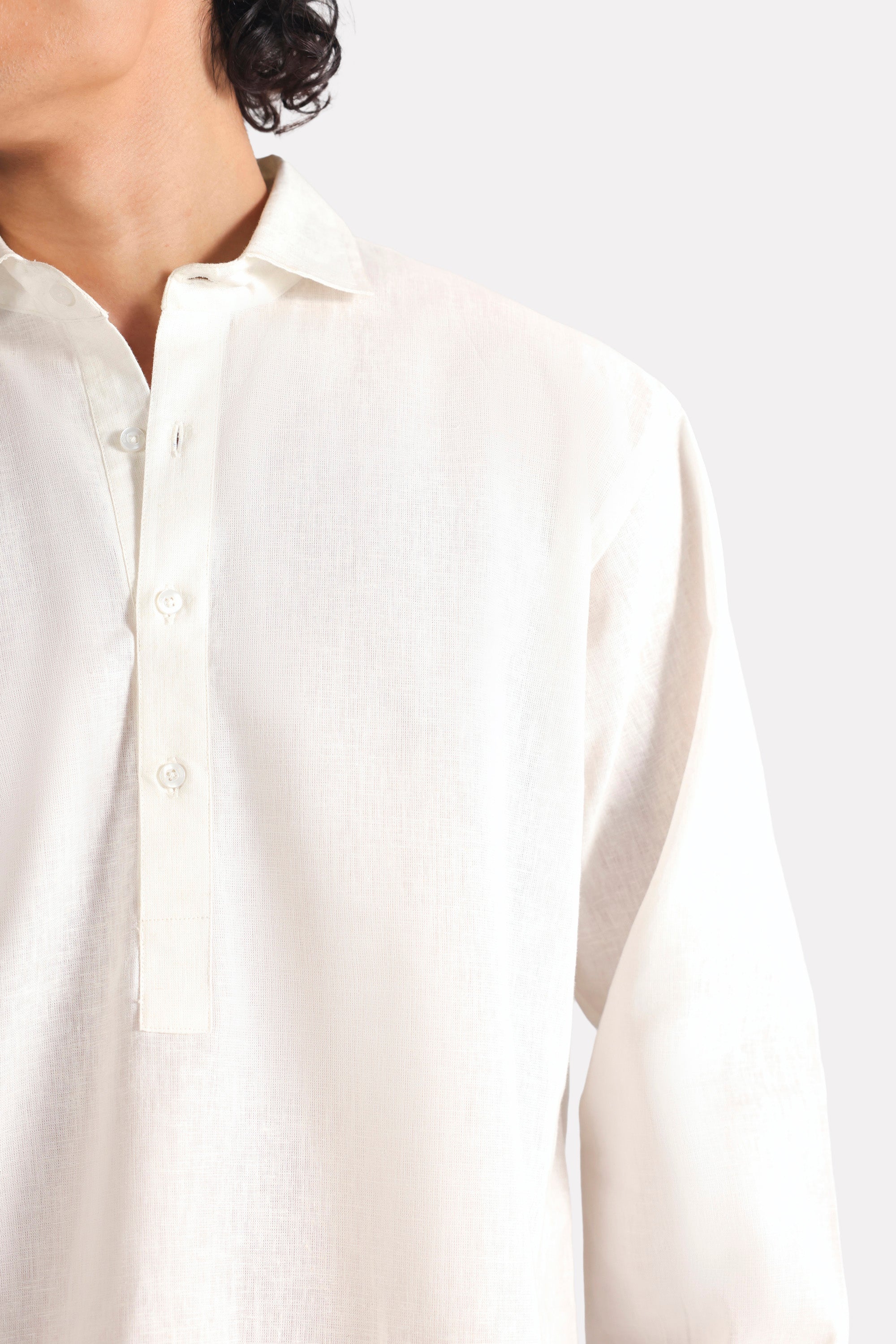 White pop over half-placket shirt shown in a styled fit, by SOLA Pakistan.