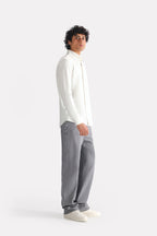 White regular fit pique shirt shown in a styled fit, by SOLA Pakistan.