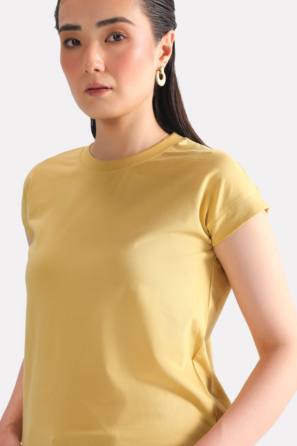 Close-up detail on the beige cap sleeve t-shirt, by SOLA Pakistan.