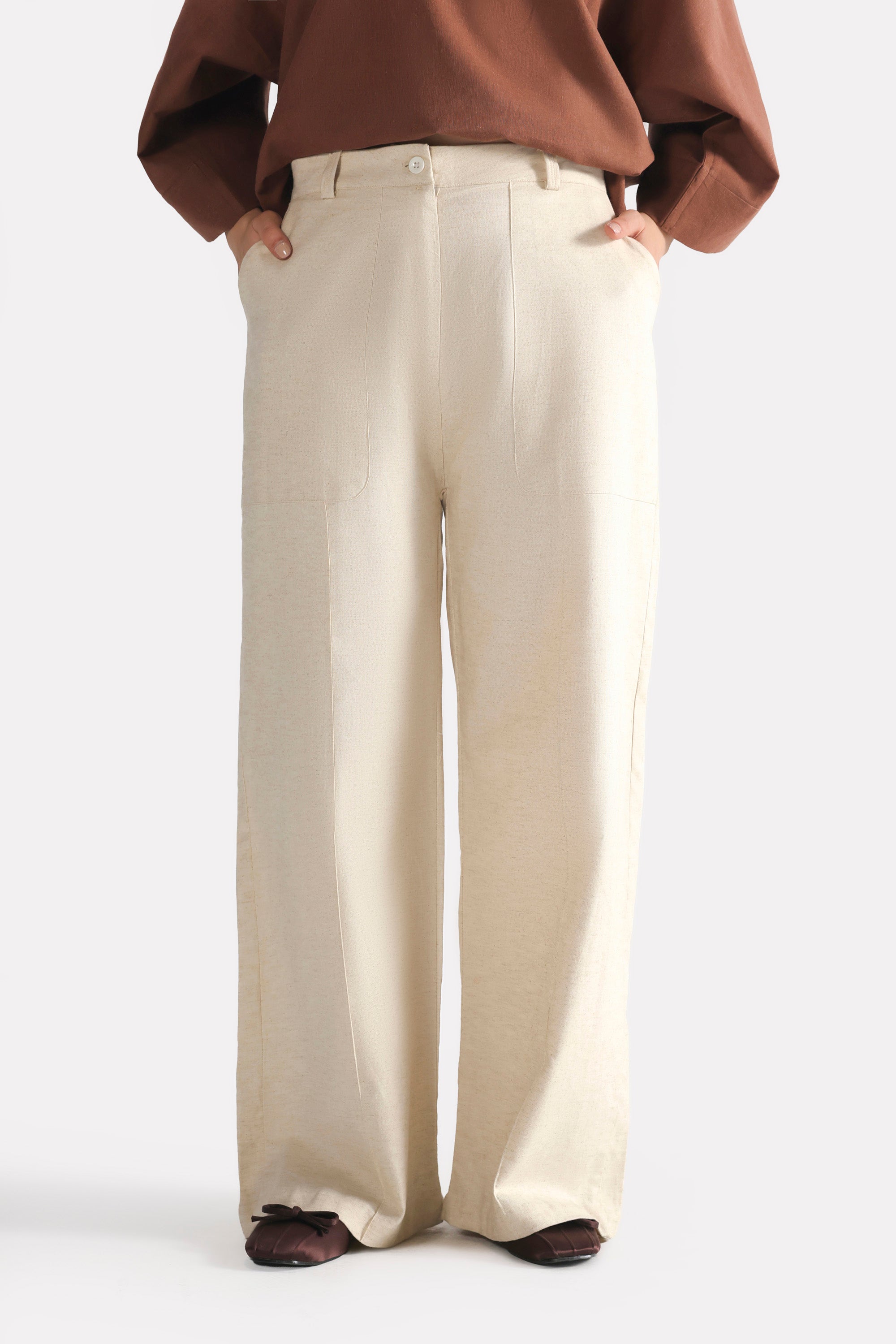 Close-up detail on the beige patch pocket trouser, by SOLA Pakistan.