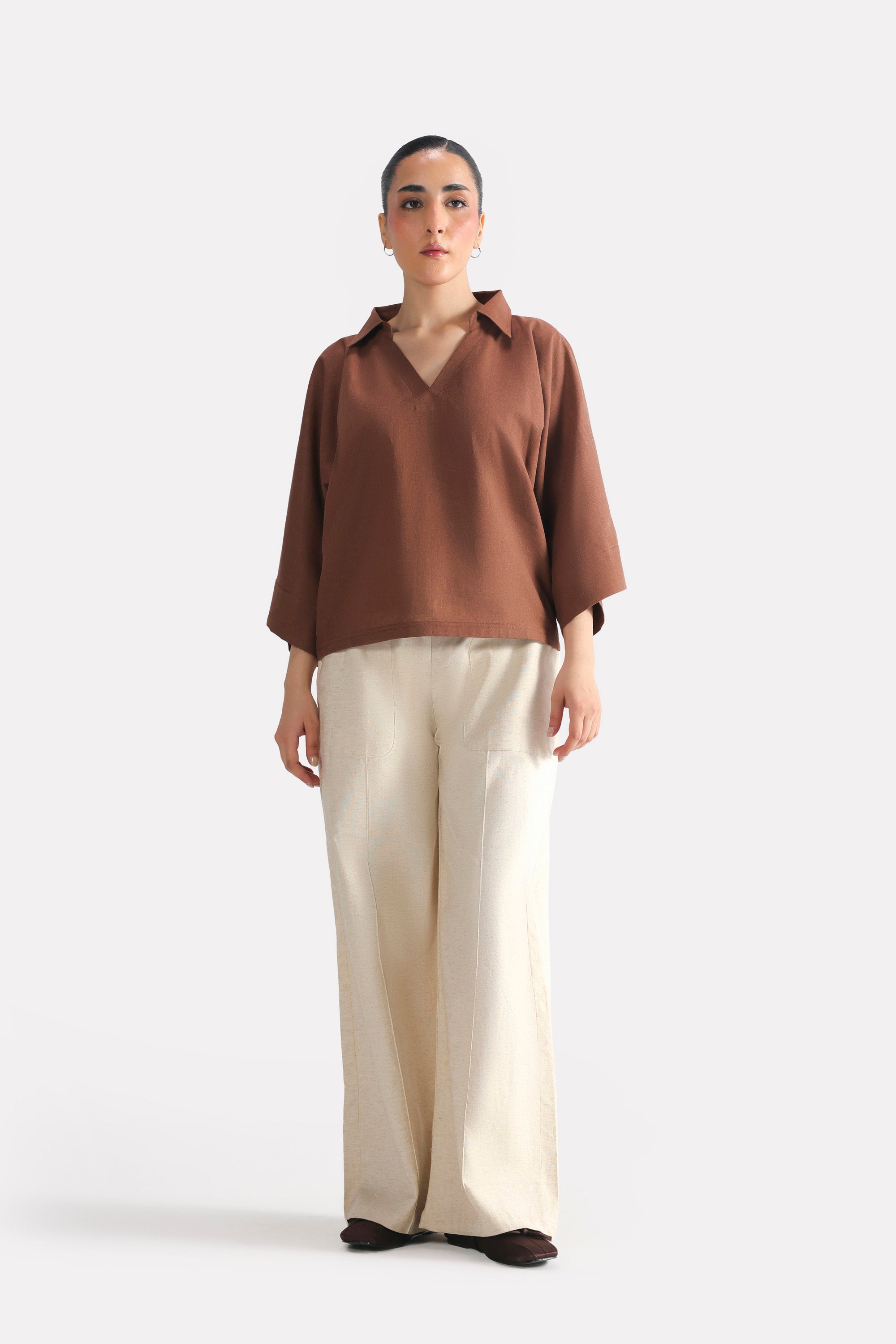 Beige patch pocket trouser in cotton-linen blend, worn by a model, by SOLA Pakistan.