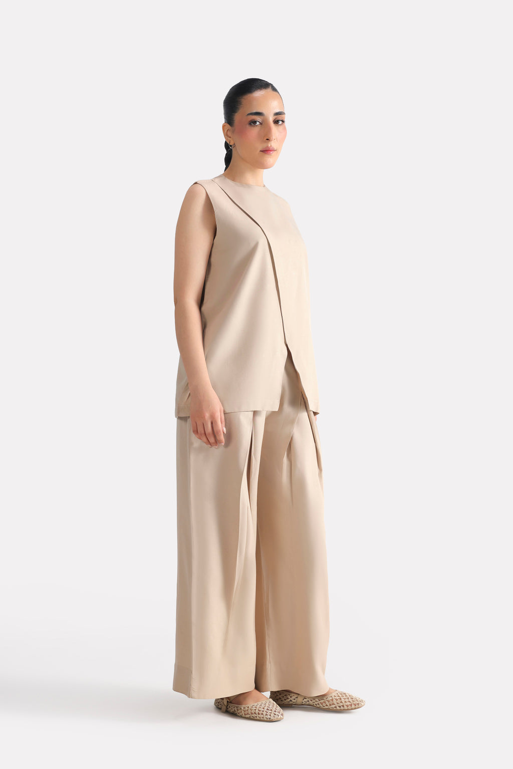 Flat lay of the beige pleated co-ord bottom, by SOLA Pakistan.