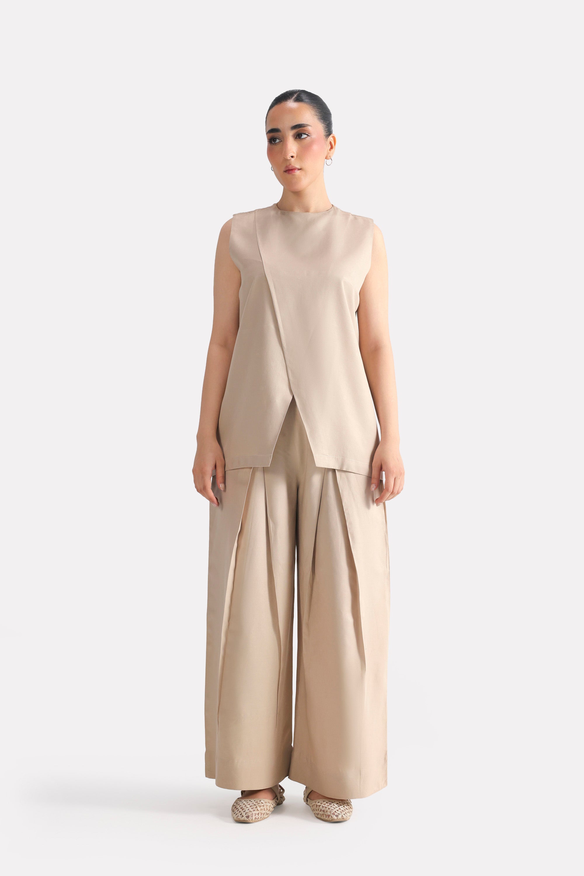 Close-up detail on the beige pleated co-ord top, by SOLA Pakistan.