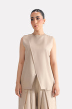 Beige pleated co-ord top in polyester-silk blend, worn by a model, by SOLA Pakistan.