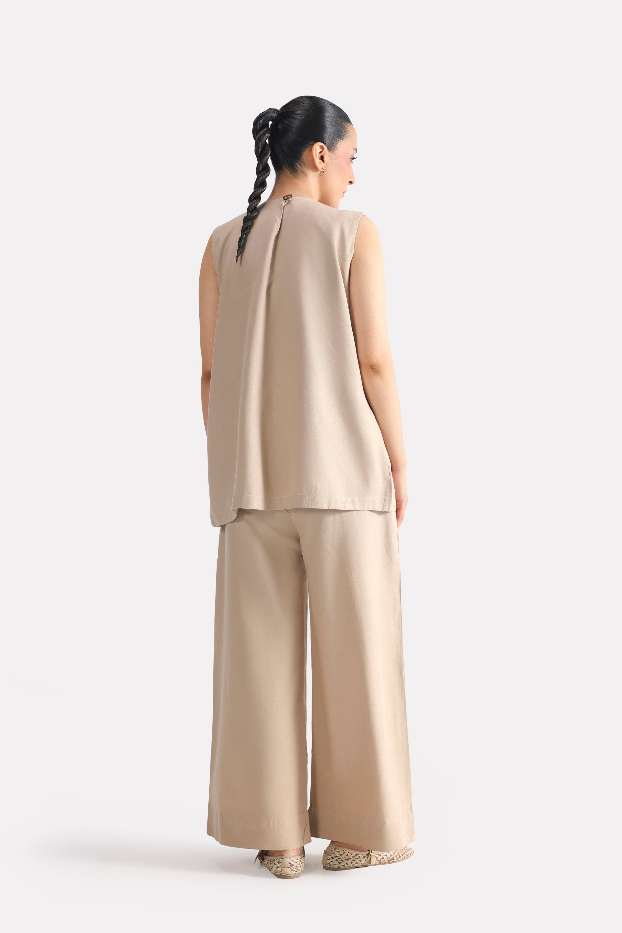 Texture and fabric detail, beige pleated co-ord top, by SOLA Pakistan.