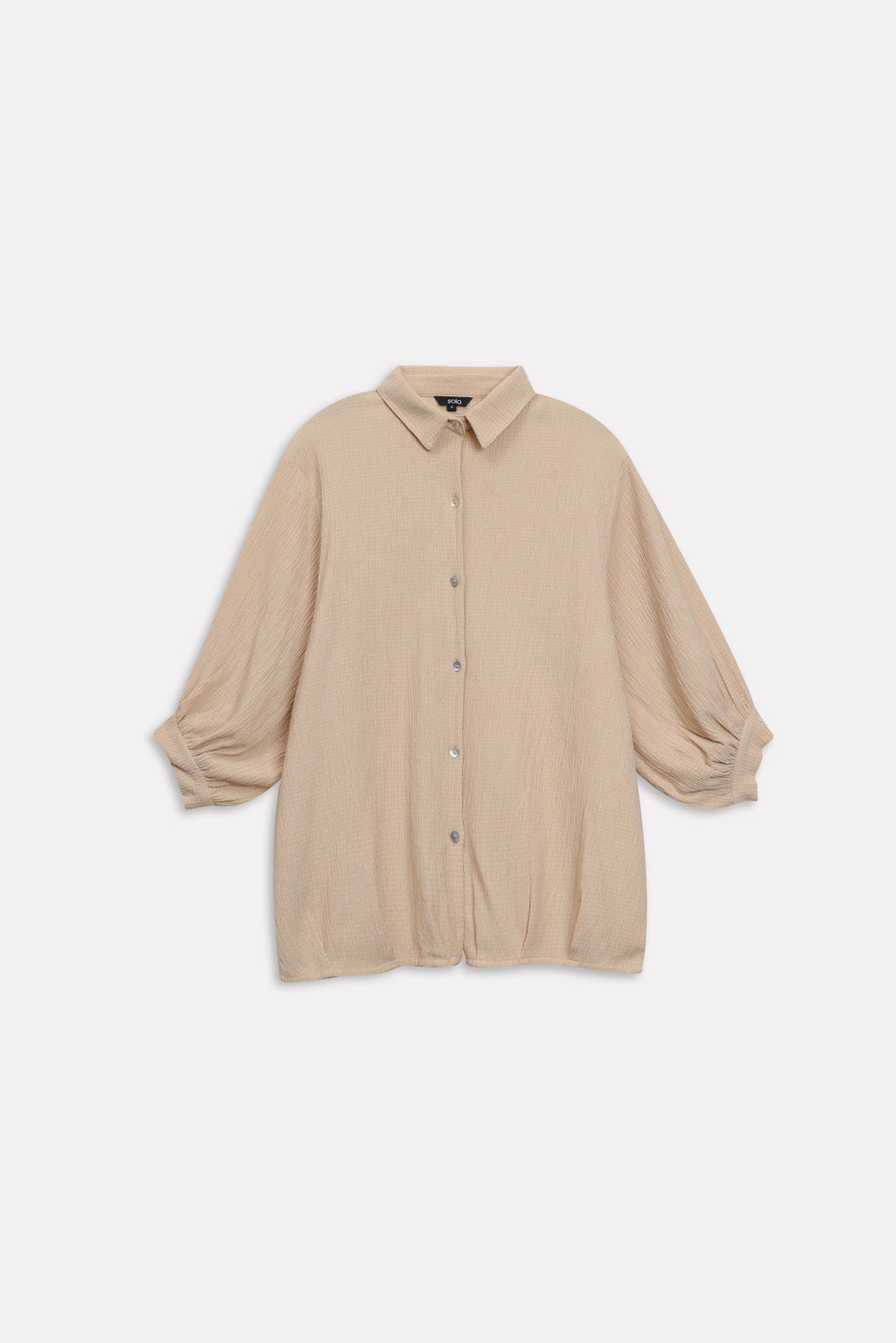 Close-up detail on the beige pleated hem woven top, by SOLA Pakistan.