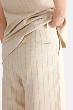 Close-up detail on the beige print linen blend tailored co-ord bottom, by SOLA Pakistan.