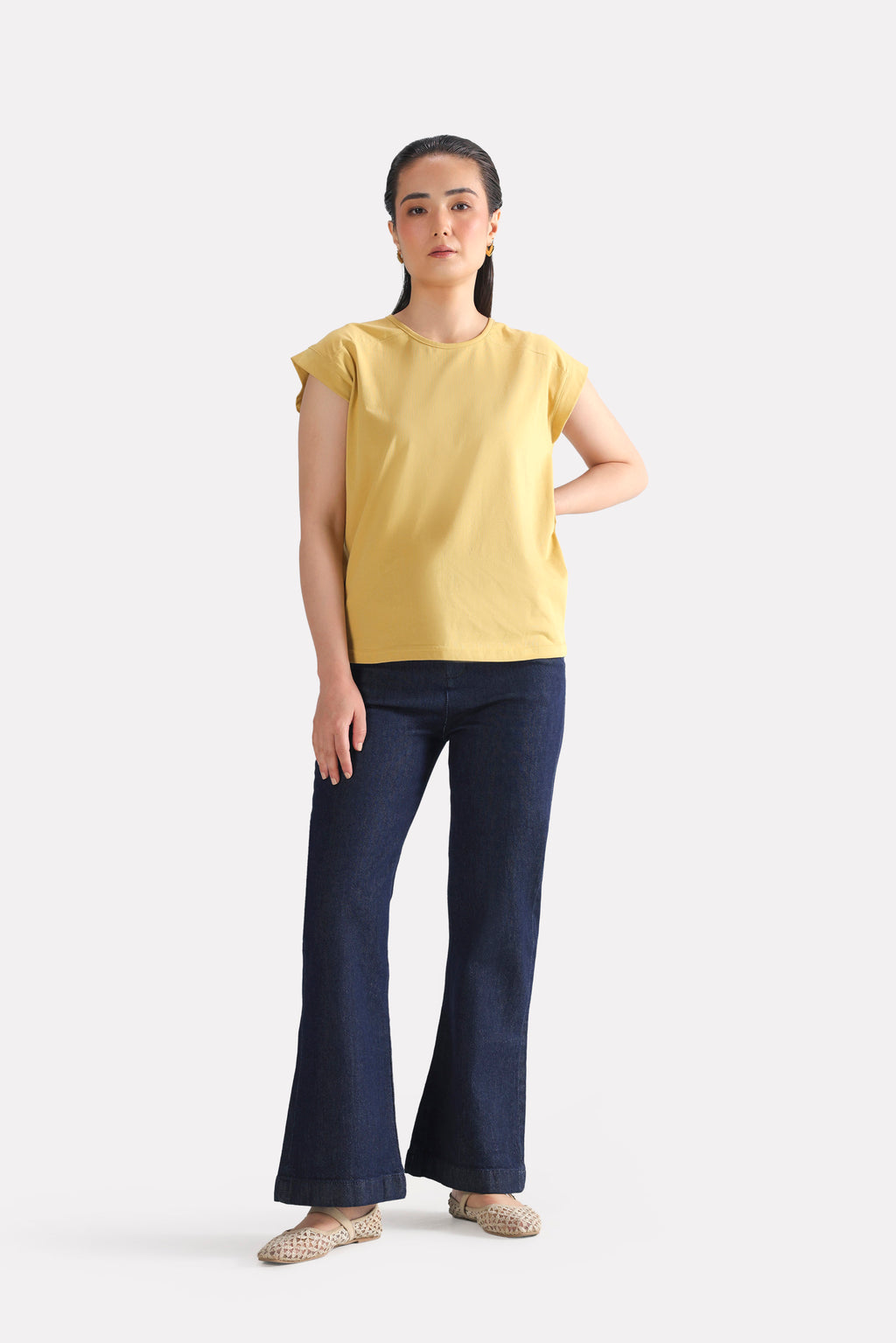 Close-up detail on the beige relaxed shoulder-tab t-shirt, by SOLA Pakistan.