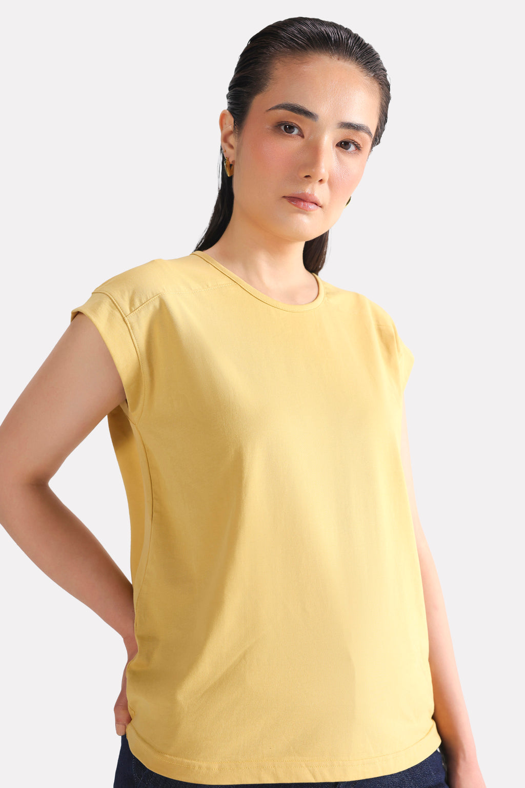 Beige relaxed shoulder-tab t-shirt shown in a styled fit, by SOLA Pakistan.