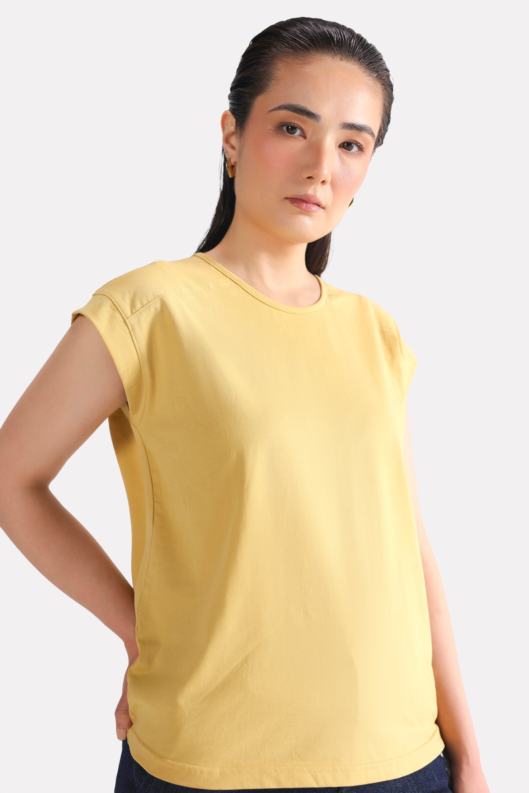 Beige relaxed shoulder-tab t-shirt shown in a styled fit, by SOLA Pakistan.