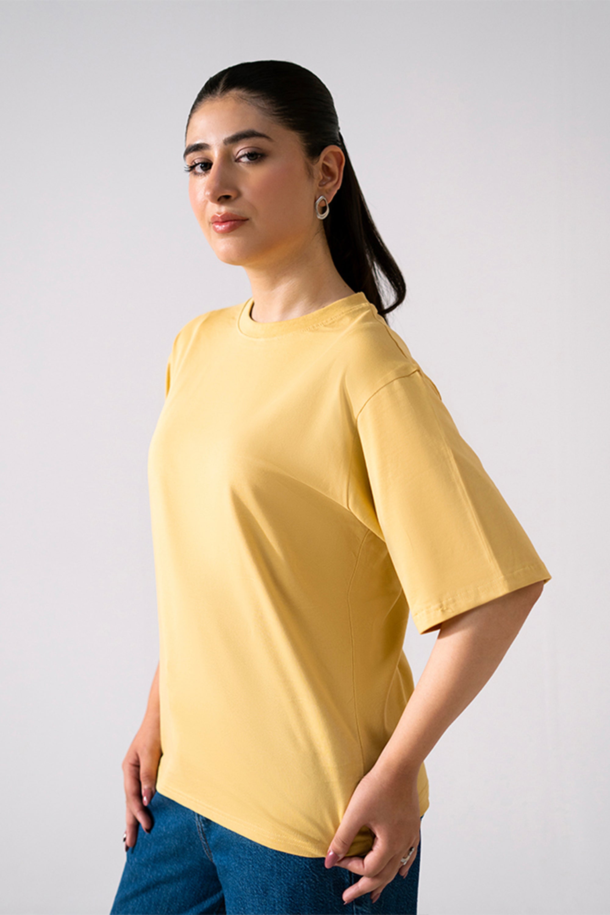 Close-up detail on the beige round neck t-shirt, by SOLA Pakistan.