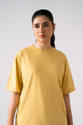 Beige round neck t-shirt in cotton, worn by a model, by SOLA Pakistan.