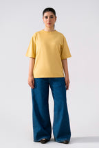 Beige round neck t-shirt shown in a styled fit, by SOLA Pakistan.