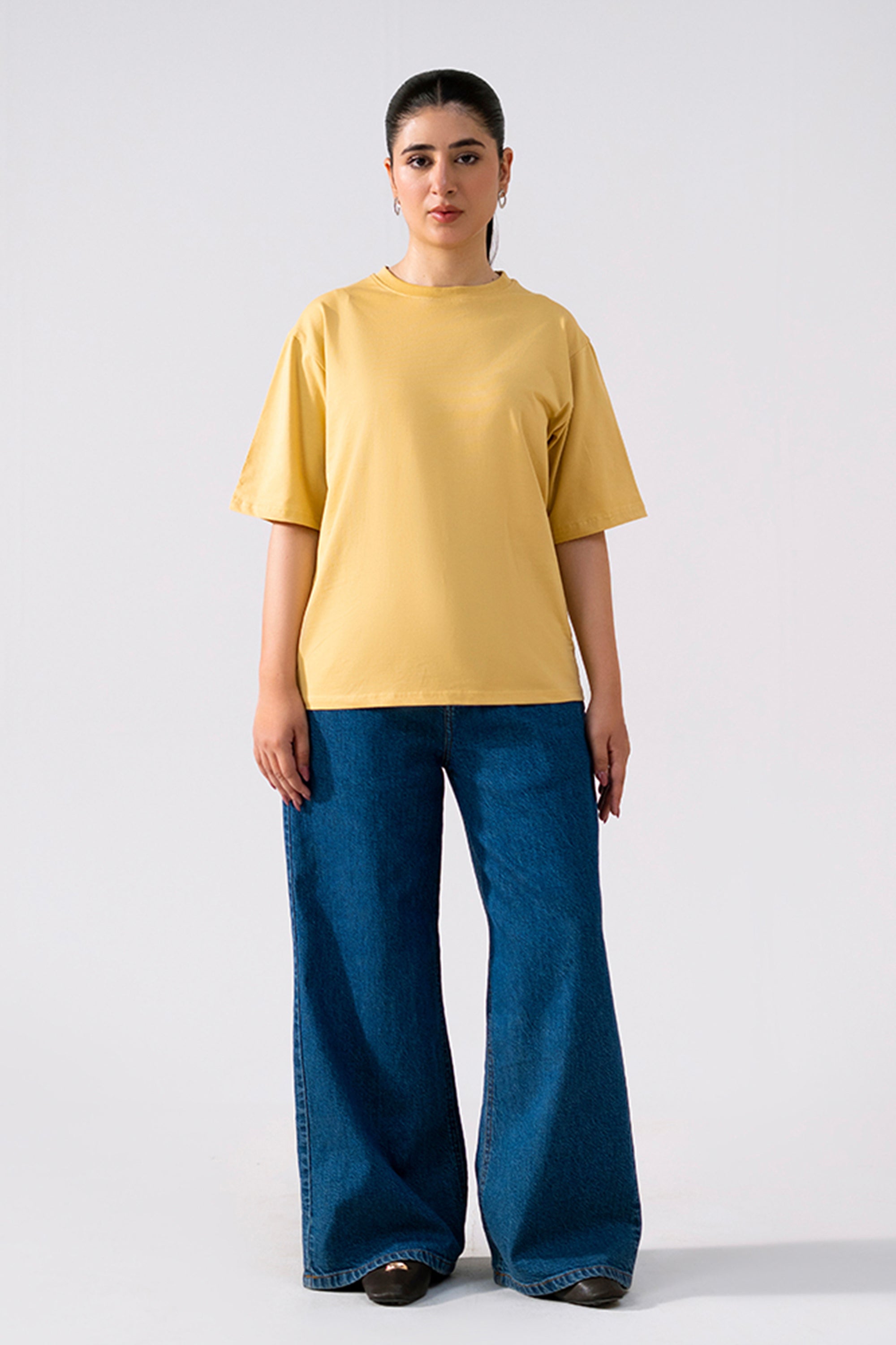Beige round neck t-shirt shown in a styled fit, by SOLA Pakistan.