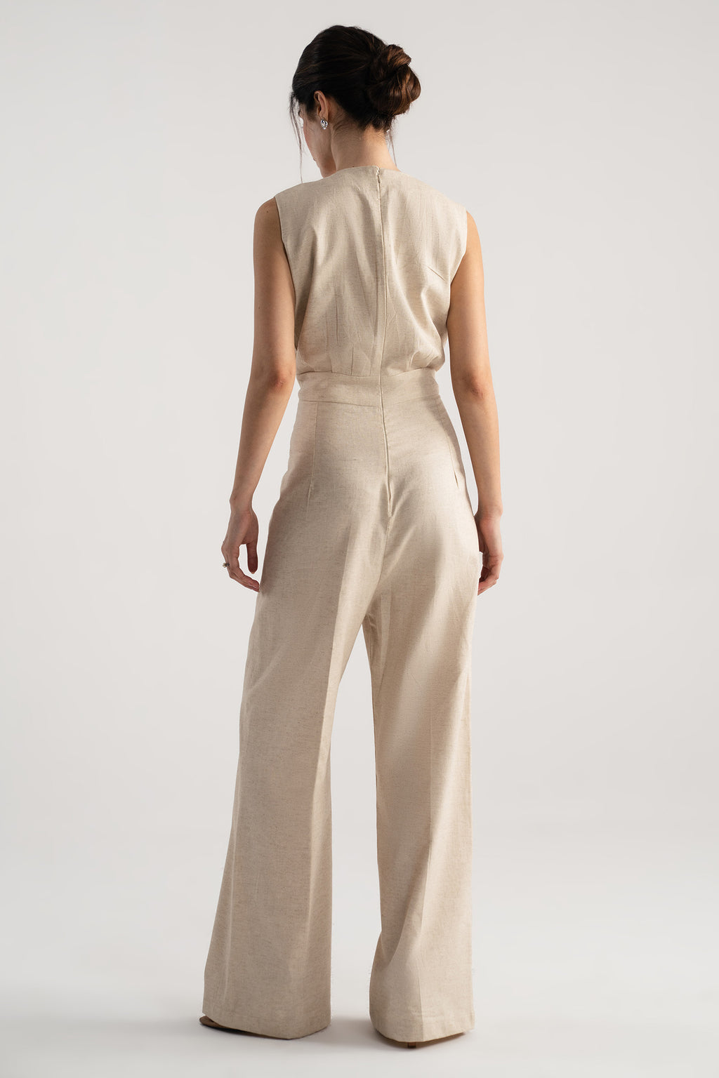 Close-up detail on the beige sleeveless wrap style wide leg jumpsuit co-ord, by SOLA Pakistan.