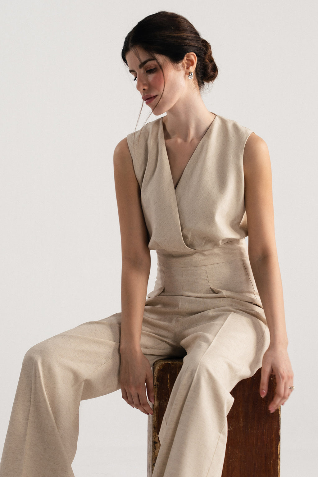 Flat lay of the beige sleeveless wrap style wide leg jumpsuit co-ord, by SOLA Pakistan.