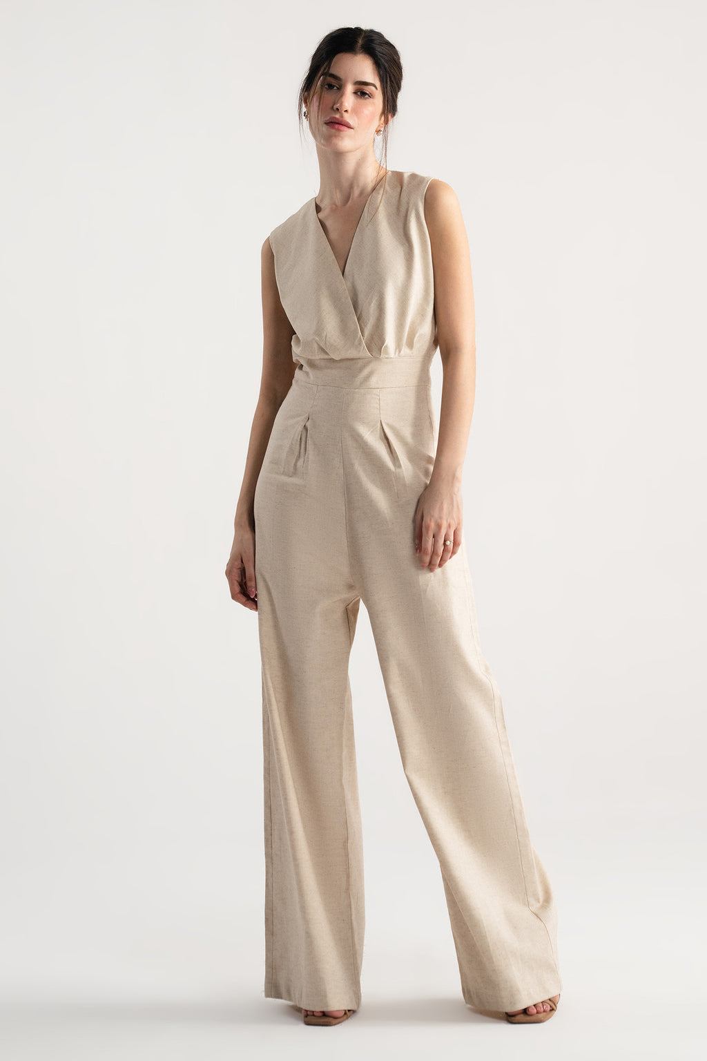 Beige sleeveless wrap style wide leg jumpsuit co-ord, worn by a model, by SOLA Pakistan.