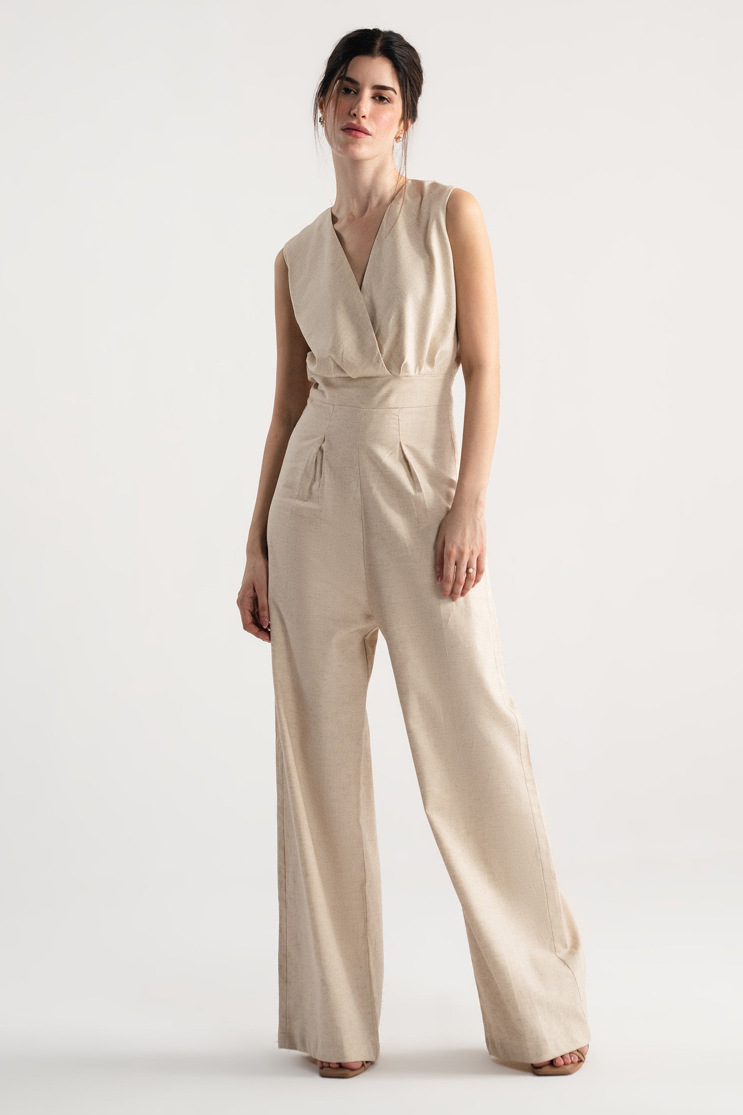 Beige sleeveless wrap style wide leg jumpsuit co-ord, worn by a model, by SOLA Pakistan.