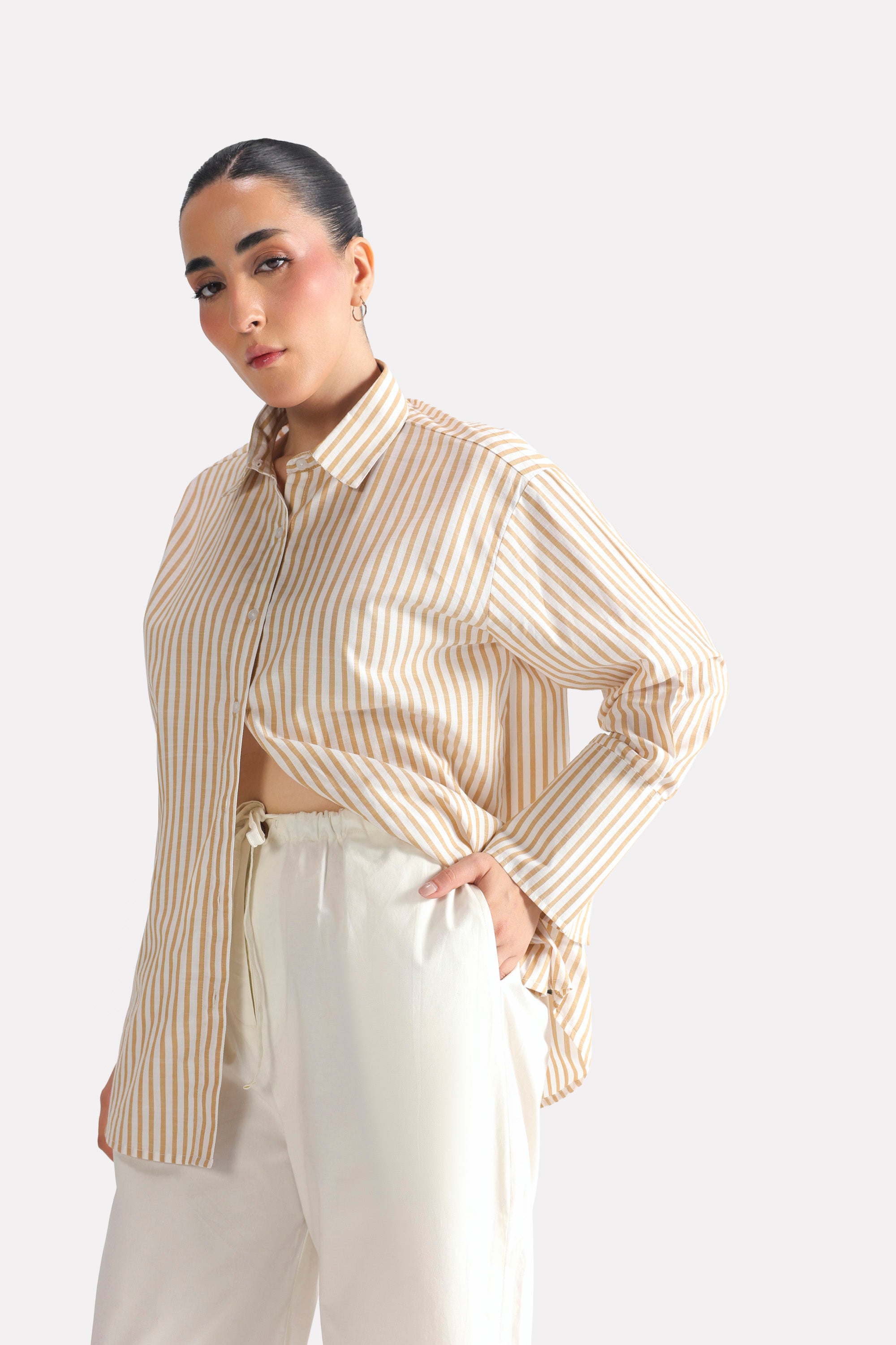 Beige & white stripe button-up stripe shirt in cotton, worn by a model, by SOLA Pakistan.