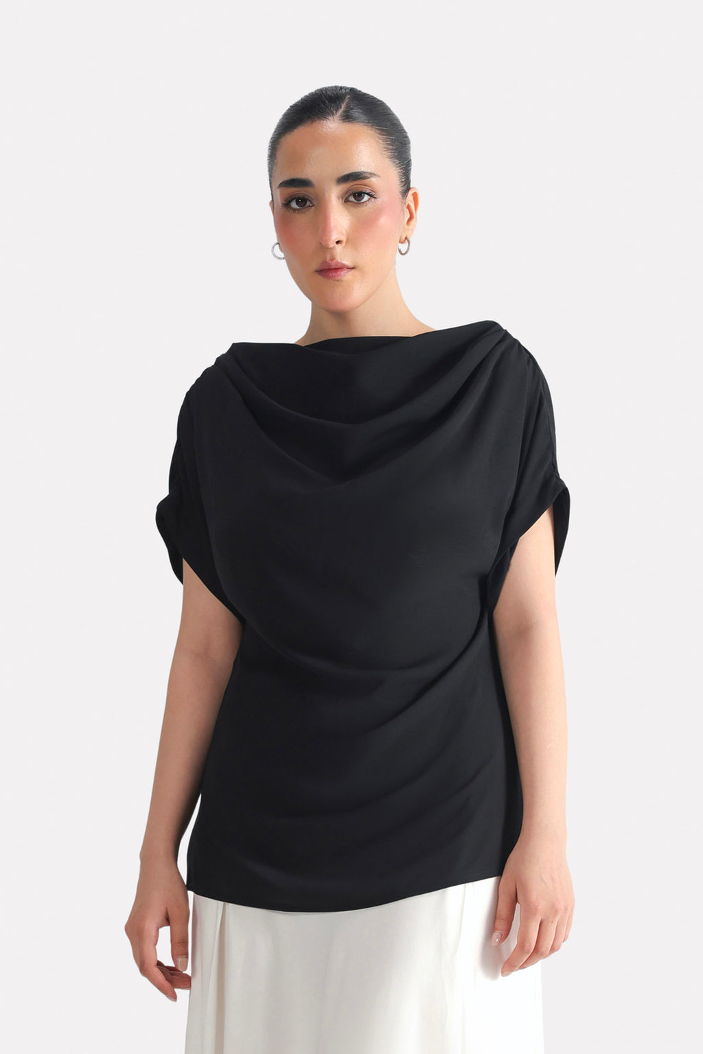 Black batwing sleeve top in polyester-silk blend, worn by a model, by SOLA Pakistan.
