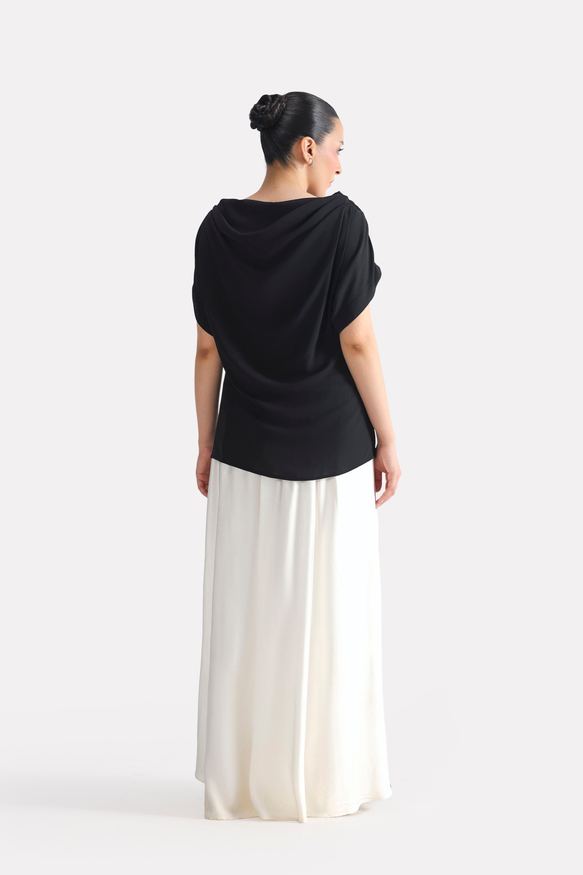 Black batwing sleeve top shown in a styled fit, by SOLA Pakistan.