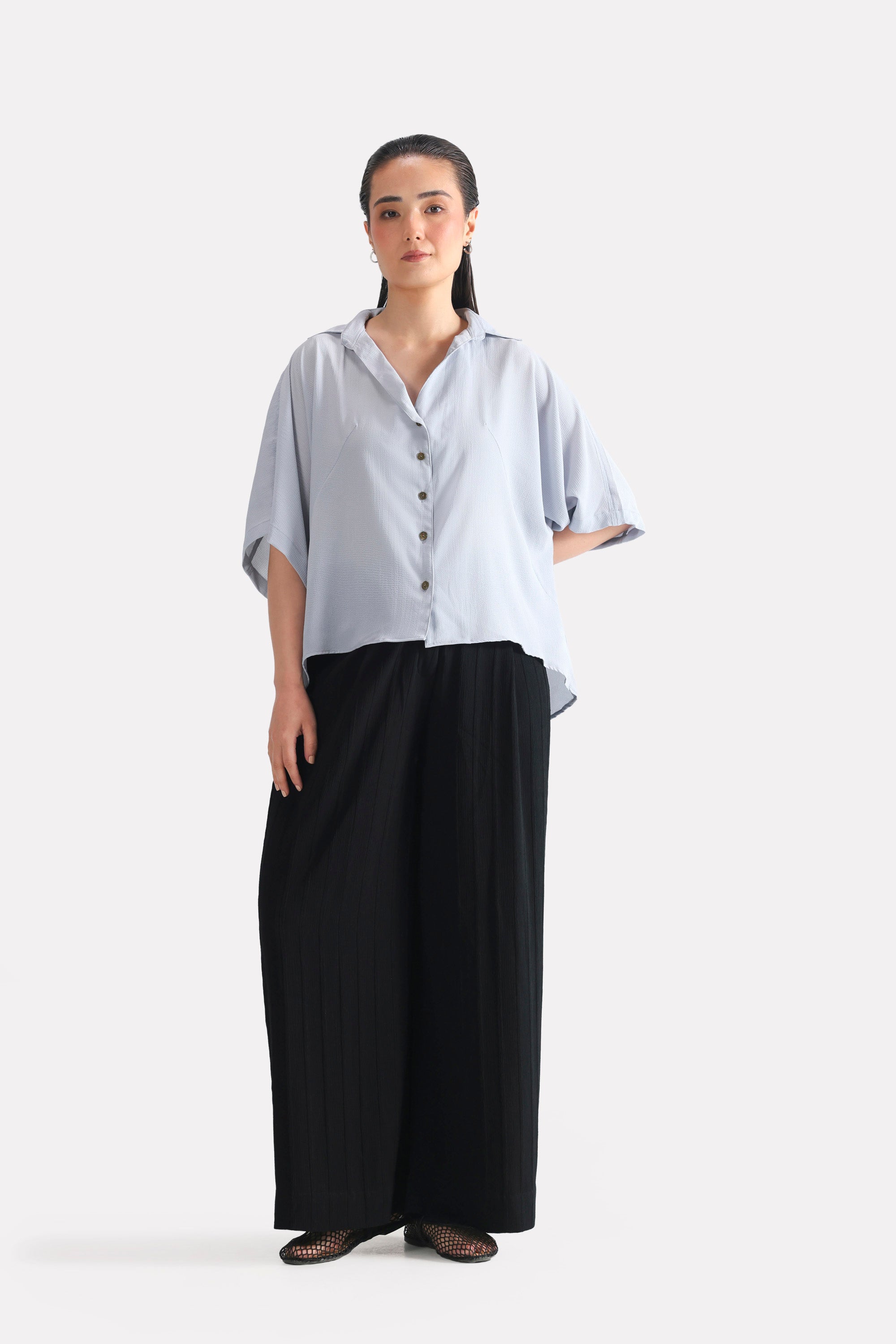 Black bubble georgette trouser in polyester crepe, worn by a model, by SOLA Pakistan.