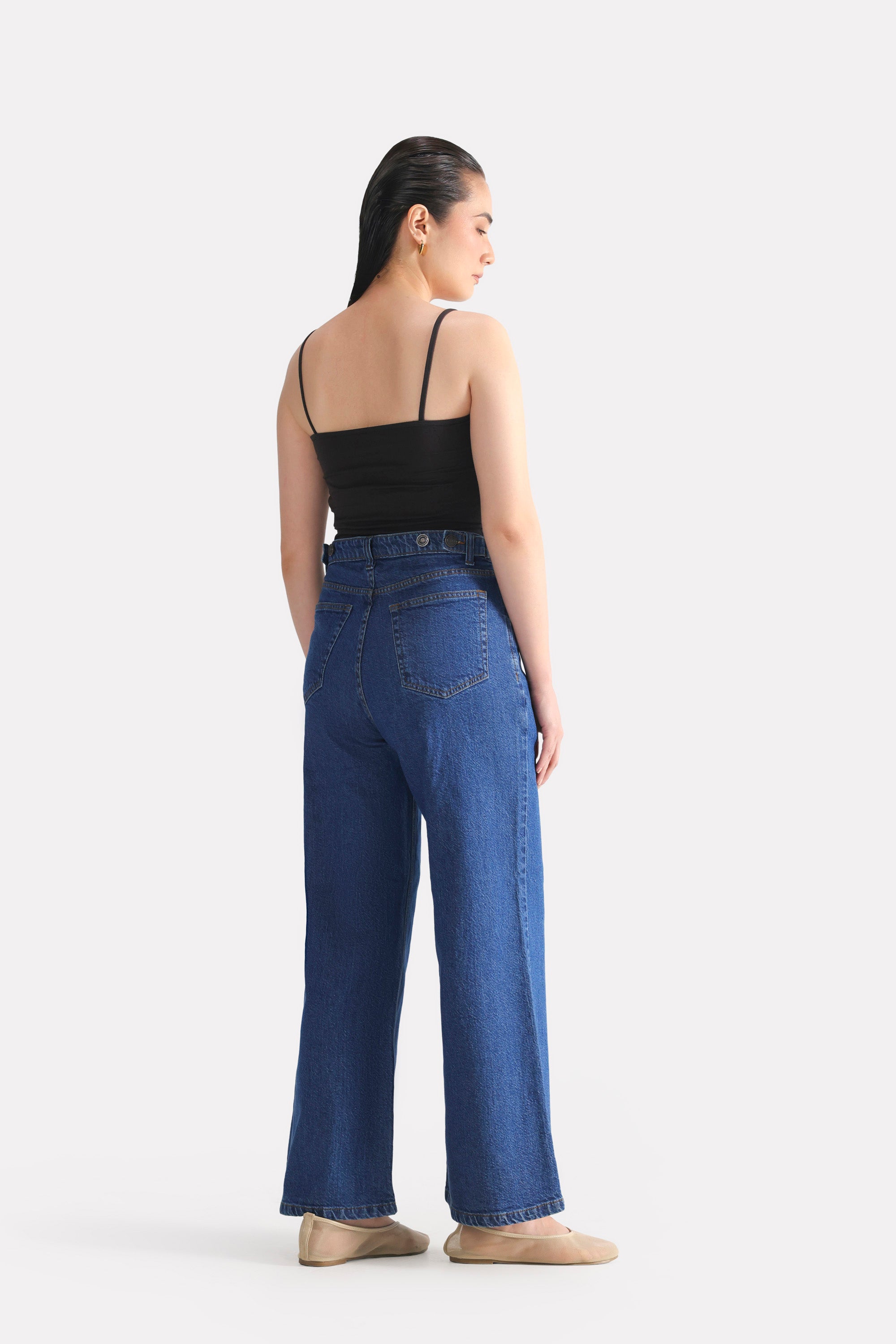 Black camisole shown in a styled fit, by SOLA Pakistan.