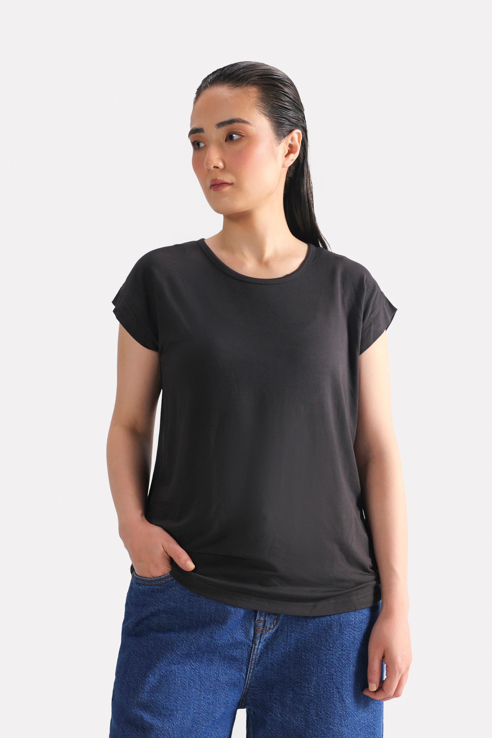 Black featherweight modal t-shirt, worn by a model, by SOLA Pakistan.