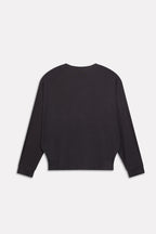 Flat lay of the black fluid sleeve t-shirt, by SOLA Pakistan.