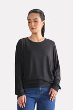 Black fluid sleeve t-shirt in modal, worn by a model, by SOLA Pakistan.